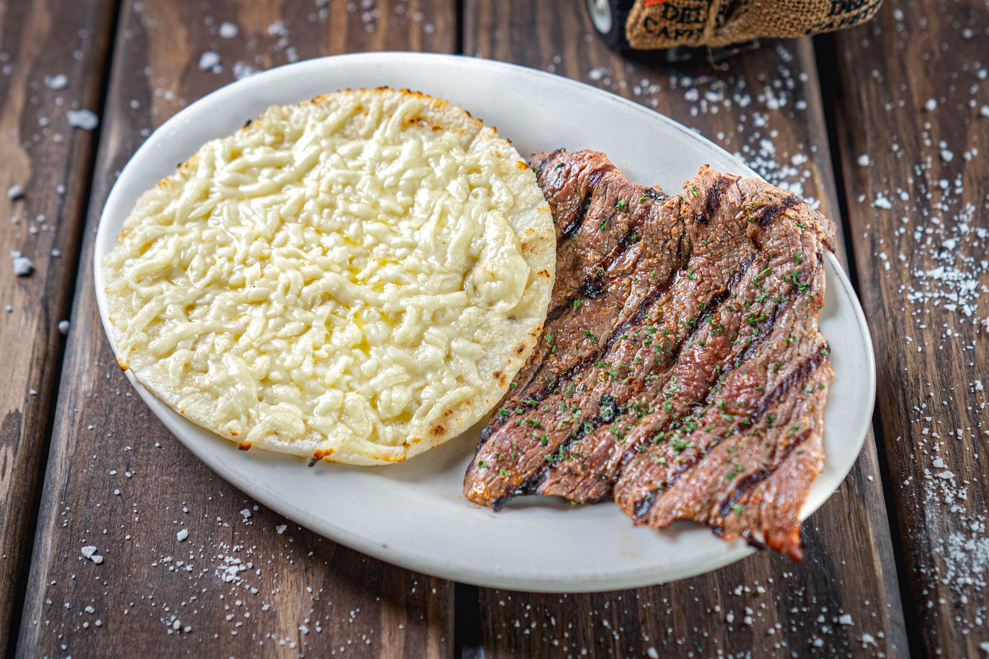 Arepa Con Queso Y Carne Asada, as photographed for the restaurant's online menu.
